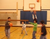student's playing basketball in a gym