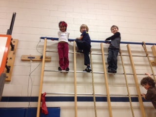 students climbing in gym