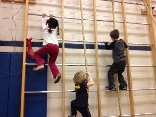 students climing a wall